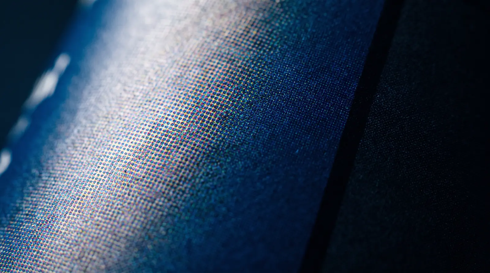 Macro of CMYK halftone dots forming a continuous-tone image
