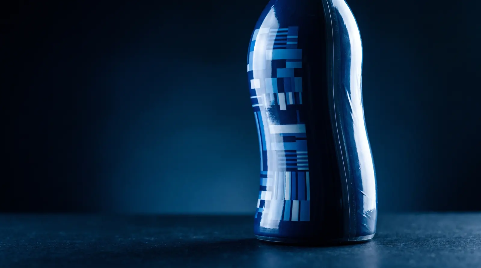A shrink sleeve conforming tightly to a waisted bottle