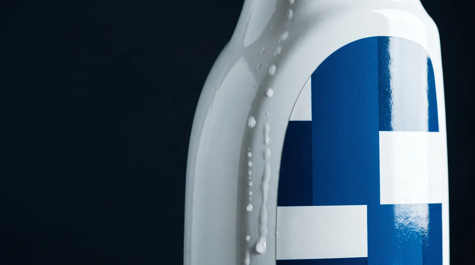 A cleaning bottle with liquid beading off a laminated label